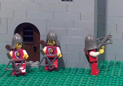 Knights in the courtyard shoot attackers on the walls