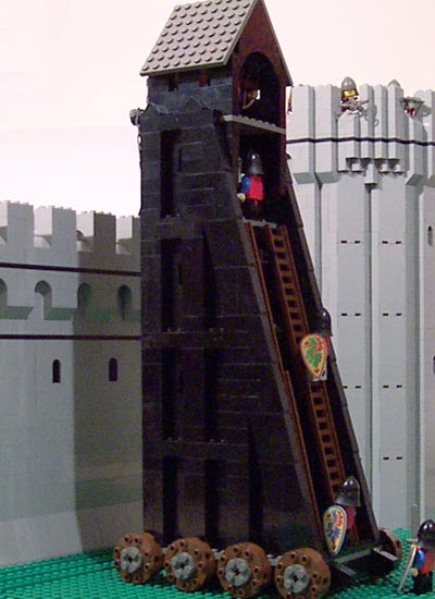 The seige tower is in place against the wall.